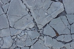 texture of gray pieces of stones with cracks on the ground 