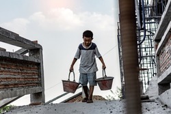 Children working at construction site for world day against child labor concept: