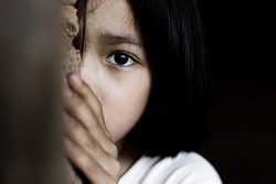 Little girl with eye sad and hopeless. Human trafficking and fear child concept. 