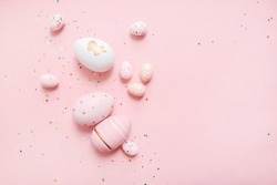 
cute easter composition. painted eggs, confetti  on a pastel pink background. top view. copy space. flat lay. place for text