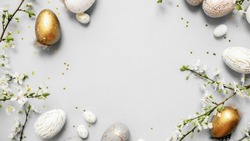 beautiful light easter layout with marble eggs, cherry blossoms and confetti on a white background. top view. copy space. flat lay. place for text