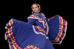 
Latin woman dressed in a dress from Jalisco Mexico, purple skirmish with ribbons of bright colors, braids and in movement skirt and smile, black background
