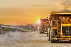 Large Yellow Dump Trucks transporting Platinum ore for processing