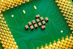 Macro Close up of microchips and pins on Main CPU PC processor circuit board.
