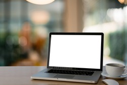 Mockup image of laptop with blank white screen on glass table at outdoor with green nature background light bokeh.- Image