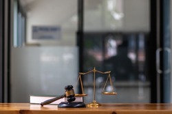 The gavel is placed on the desk next to the law book in the office that serves as a legal advisor. good-looking image of a legal counsel's office will make those seeking legal advice more trustworthy.