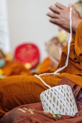 The thread is part of a religious ritual that will connect the people who attended the ceremony to pray and pray to send the souls of the deceased to heaven and find happiness after the dead