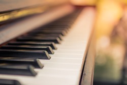 Select focus and soft focus.Close-up of a wooden piano set near a window to receive warmth from the sunshine in the morning of winter in Thailand.
The most melodious musical instrument in a beautiful 