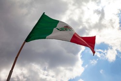 mexican flag flying on a flagpole in a mexican house. Mexico independence day concept
