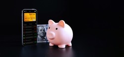 Online payment. Mobile phone with internet online bank app. Hundred dollar bill on black background. Online wallet save money
