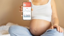 Pregnancy app. Mobile pregnancy online maternity application. Pregnant mother using phone. Pregnancy, medicine, pharmaceutics, health care and people concept.