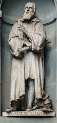 A statue of Galileo Galilei sitting outside of the Uffizi, in Florence