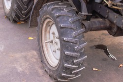 tractor wheel with suspension on asphalt.