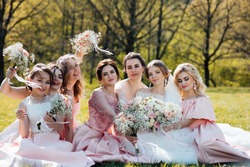 Group portrait of bride and bridesmaids. Wedding. Bride in wedding dress and bridesmaids in pink dresses at wedding day. Stylish wedding in pink color. Marriage concept.