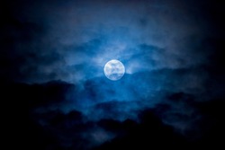 Blue moon surrounding by clouds