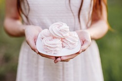 Sweet homemade marshmallows in female hands. Healthy food
