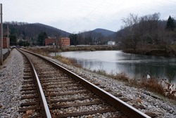 Train tracks run along the river and through a small town in West Virginia's coal country
