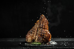 The T-bone or porterhouse steak of beef cut from the short loin. steaksT-shaped bone with meat on each side. banner, catering menu recipe place for text.