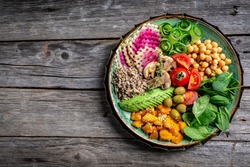 healthy vegan lunch buddha bowl. Avocado, quinoa, tomato, cucumber, vegetables salad. Delicious breakfast or snack, Clean eating, dieting, vegan food concept. top view.