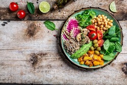 Buddha Bowl with Quinoa, Avocado, mushrooms, cucumber, chickpeas, spinach, tomatoes, avocado vegetables salad. Clean eating dieting vegan food concept. top view.