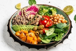 Buddha Bowl with Quinoa, Avocado, mushrooms, cucumber, chickpeas, spinach, tomatoes, avocado vegetables salad. Clean eating dieting vegan food concept. top view.