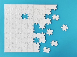 White jigsaw puzzle on blue background