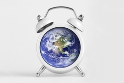 Earth day concept. Planet Earth globe with alarm clock.