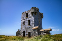 Ruin of an old signal tower and coast guard station on Brow Head, West Coast of Ireland 