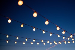 Lights hang overhead on a clear summer night