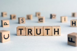 Truth - word from wooden blocks with letters, real facts truth  concept, random letters around, white  background