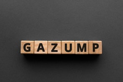 Gazump - words from wooden blocks with letters, rip off; ask an unreasonable price gazump concept, top view gray background