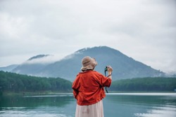 The young women take a photo at the beautiful view at the lake.Tuyen Lam Lake , Dalat , Vietnam
