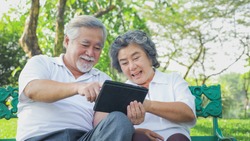 happy senior couple embracing Video call on smart phone mobile with children and family feeling happy and smile sitting in the bed at home, Old elderly couple retirement lifestyle concept.