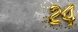 Yellow foil balloon number, number twenty-four on a concrete background. 24th birthday card. Anniversary concept. for anniversary, birthday, new year celebration. banner, copy space.