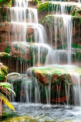 Blurred motion waterfall on stone in beautiful nature on hills