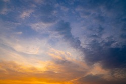 Sky and clouds concept, sunset sky and golden clouds background on blurred light of sunny colorful wallpaper, beautiful of cloudscape of view dramatic dusk, blue on top and golden on below photo