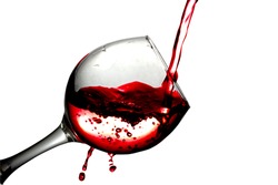 Red liquid, water, cherry juice, strawberry juice, red wine pouring into a glass, liquid in a speaker, isolated on a white background