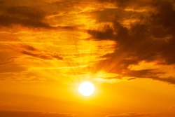 Panorama of Golden hour orange sky with clouds and the yellow sun shining nature background sunrise or sunset scene