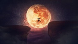 Surreal scene, self overcome concept, as determined man jump over a chasm obstacle. Way to win and success over starry night with full moon background. Motivation for achieving goals.