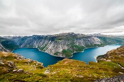 Panoramic aerial wide angle landscape from mountain viewpoint with clouds in cliff during trip Norway.. High resolution panorama, Norway. Trolltunga hiking route.