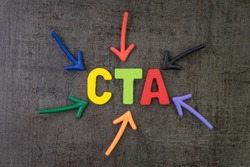 CTA, Call to action in advertising and communication concept, multi color arrows pointing to the word CTA at the center of black cement chalkboard wall.