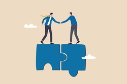 Collaborate, cooperate or partnership and agreement to help business success, together or teamwork support each other concept, success businessmen finish deal and handshake on jigsaw puzzle.