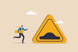 Business slow down due to obstacles, difficulty or speed limit, beware of crisis ahead or recession, economic depression concept, businessman running with arrow to find speed bump slow down sign.