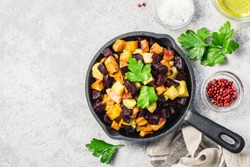 Balsamic roasted vegetables, carrots, sweet potato, pumpkin, beetroot, potato in cast iron skillet. Top view, space for text.