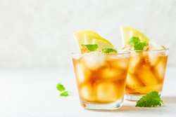 Summer refreshing drink, apple iced tea in glasses. Space for text.