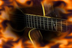 Acoustic wooden guitar with fire flame screen.