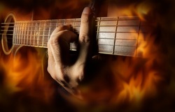 Playing acoustic guitar with fire flame screen.