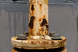 Gas connection of pipes with severe metal corrosion from weather conditions. Bolts in focus in the foreground.