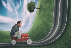 Businessman climb an uphill road with a small car. Difficult carrer concept