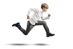 Running young boy isolated on white background